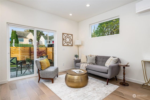 interior space with hardwood / wood-style floors and a wall unit AC