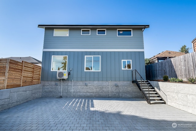 rear view of house with cooling unit