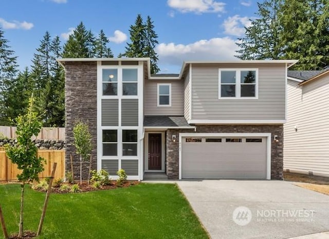 view of front of home featuring a garage and a front lawn