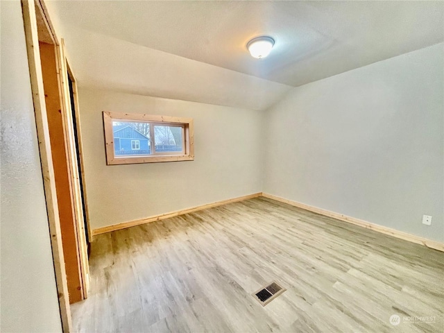 interior space with lofted ceiling and light wood-type flooring