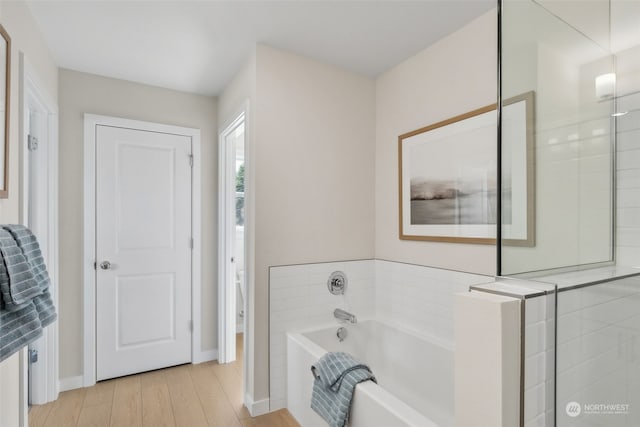 bathroom with wood-type flooring and plus walk in shower