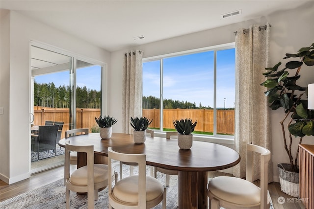 dining space with hardwood / wood-style flooring