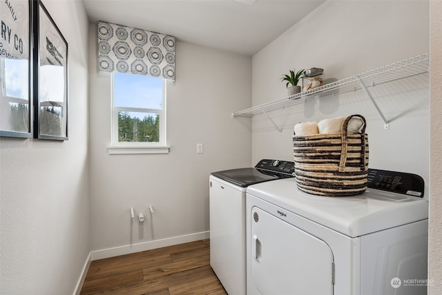 clothes washing area featuring hardwood / wood-style floors and washing machine and clothes dryer