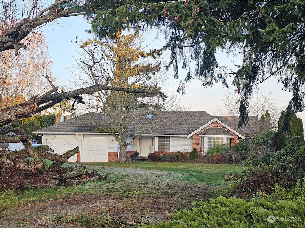 ranch-style home with a garage and a front yard