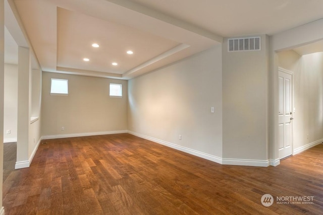 basement with dark hardwood / wood-style flooring