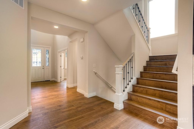 stairs featuring wood-type flooring