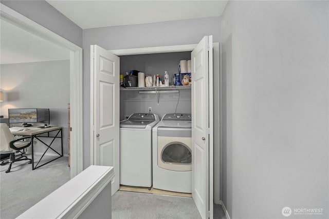 laundry area with light carpet, laundry area, and washer and clothes dryer