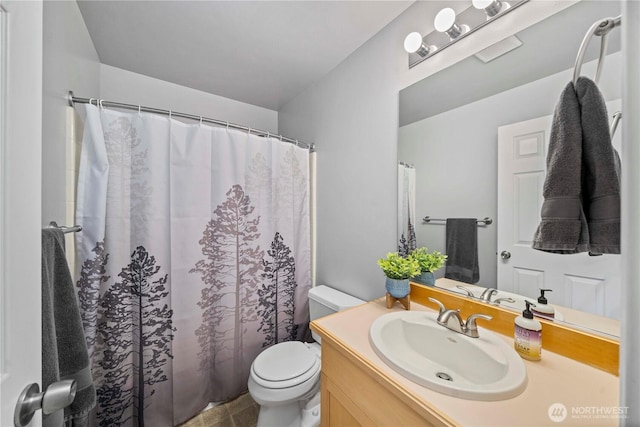 bathroom featuring toilet, vanity, and a shower with shower curtain