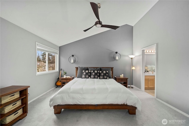 carpeted bedroom with ensuite bath, vaulted ceiling, a ceiling fan, and baseboards