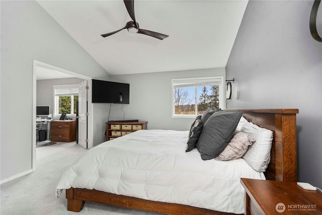 bedroom featuring light carpet, ensuite bath, baseboards, ceiling fan, and vaulted ceiling