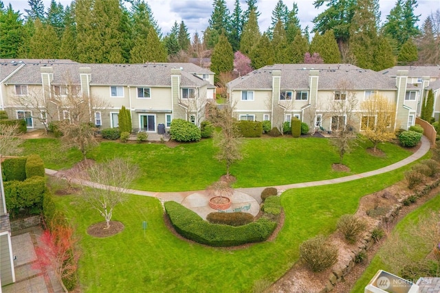 view of home's community with a residential view and a yard