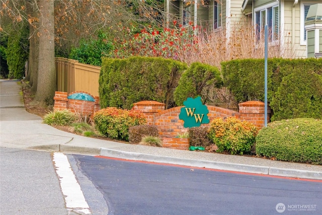 community / neighborhood sign with fence