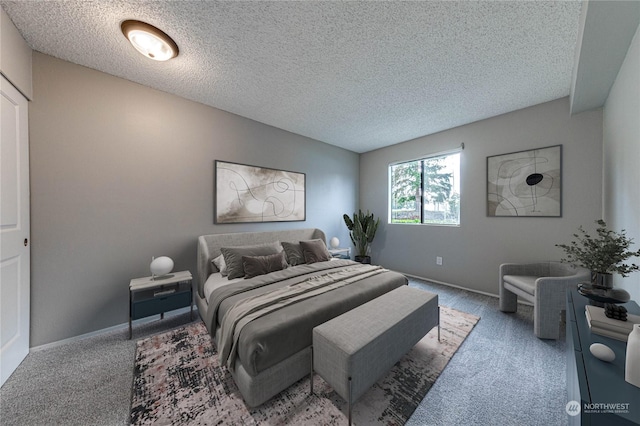 carpeted bedroom featuring a textured ceiling