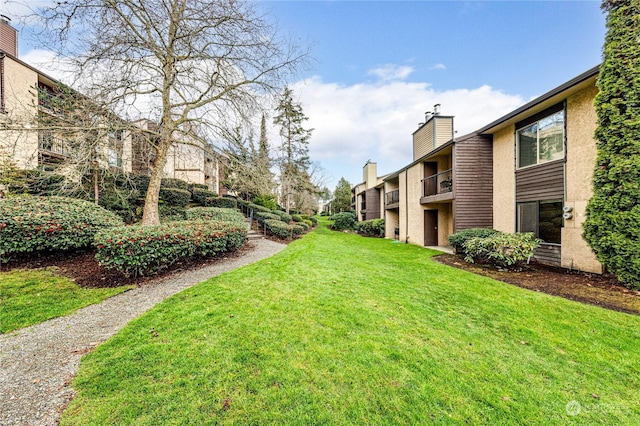 view of yard featuring a balcony