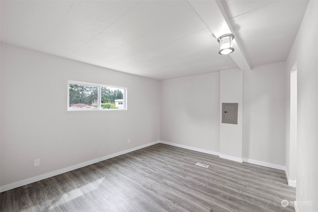 empty room featuring hardwood / wood-style flooring and electric panel