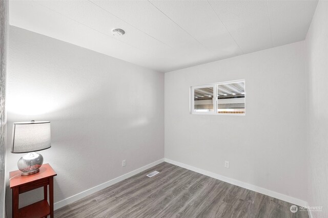 spare room with hardwood / wood-style flooring