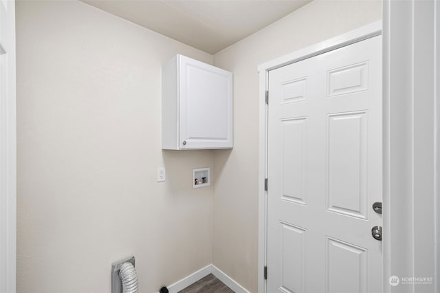 clothes washing area featuring hookup for a washing machine, dark hardwood / wood-style floors, and cabinets