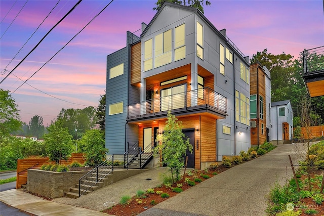 modern home featuring a balcony and a garage