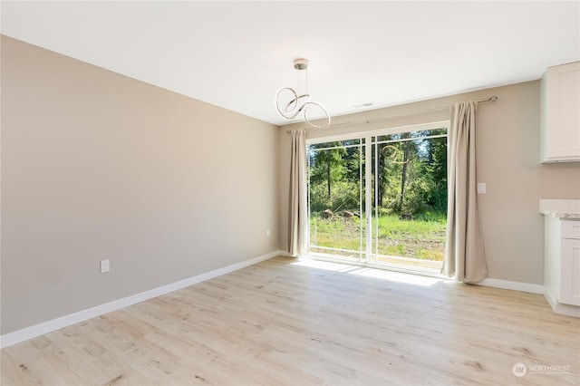 unfurnished dining area with light hardwood / wood-style flooring