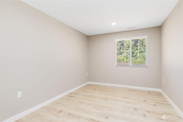 spare room with light hardwood / wood-style floors