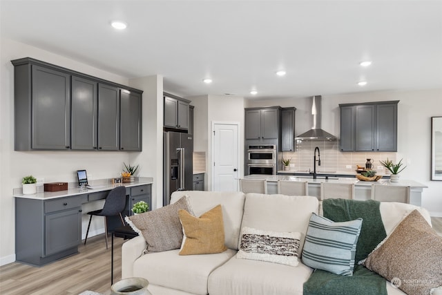 living room with sink and light hardwood / wood-style floors