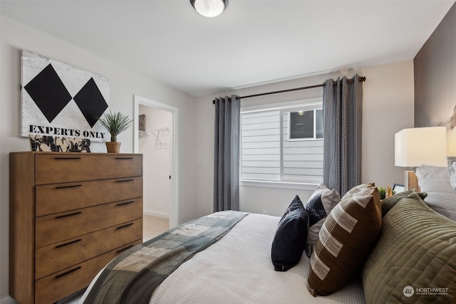 bedroom featuring a closet and a walk in closet