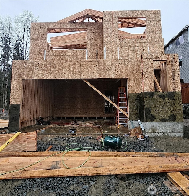 rear view of property featuring an outbuilding