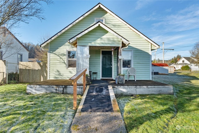 bungalow-style home featuring a front yard