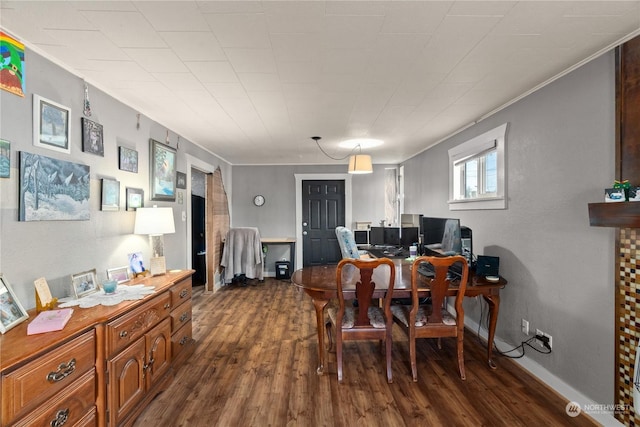 dining room with crown molding and dark wood-type flooring