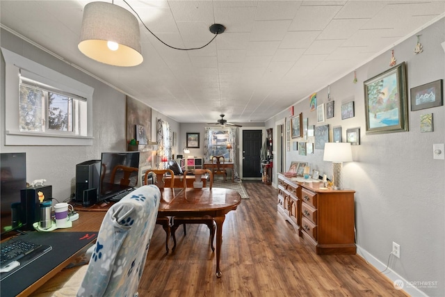 dining room featuring hardwood / wood-style flooring, ornamental molding, and ceiling fan