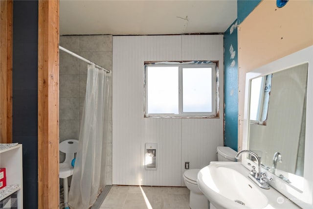 bathroom with sink, a shower with curtain, and toilet