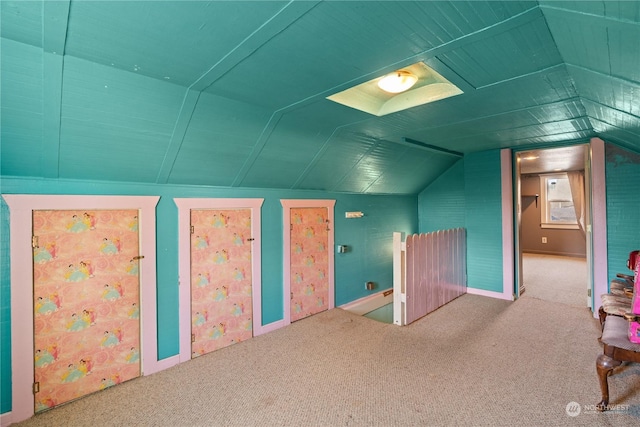 bonus room with vaulted ceiling and carpet