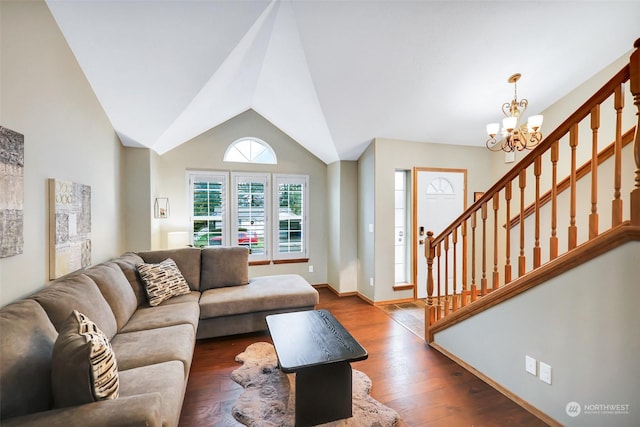 living room with vaulted ceiling, a notable chandelier, and dark hardwood / wood-style flooring