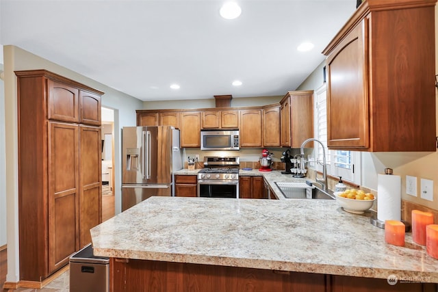 kitchen featuring sink, kitchen peninsula, and stainless steel appliances