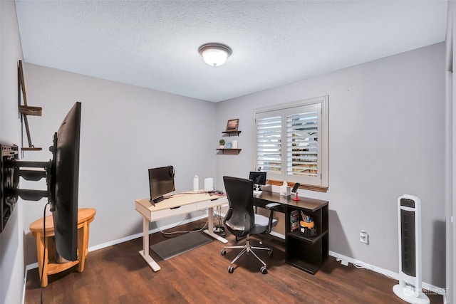 home office with a textured ceiling and dark hardwood / wood-style floors