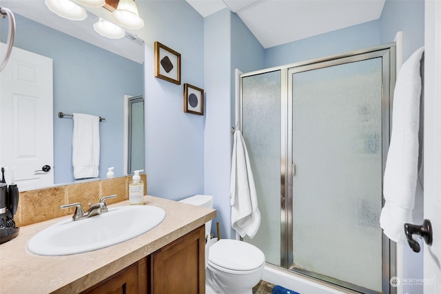 bathroom featuring toilet, walk in shower, and vanity