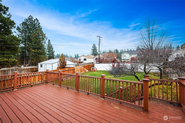 wooden terrace featuring a yard