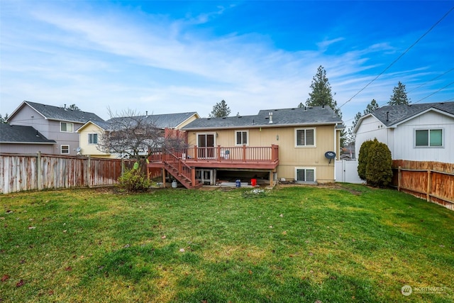 back of house featuring a wooden deck and a lawn