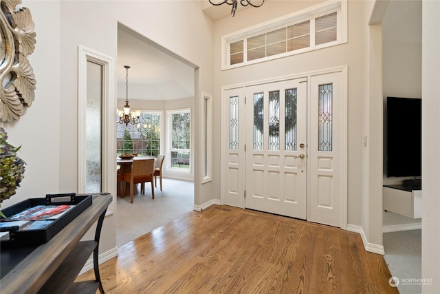 foyer featuring hardwood / wood-style flooring and a chandelier