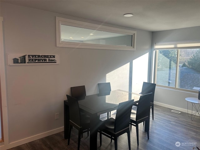 dining area with dark wood-type flooring