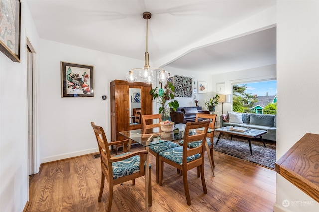 dining space with wood-type flooring