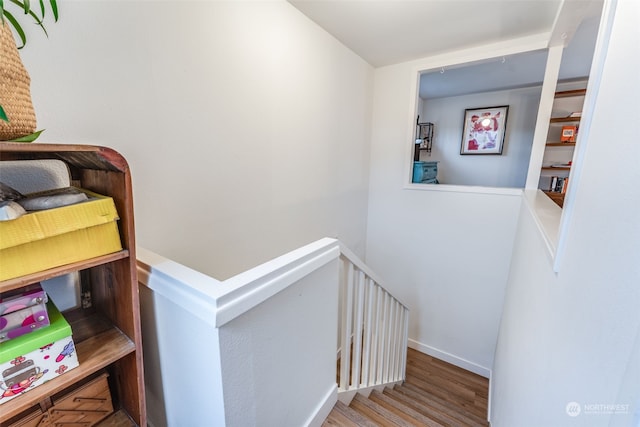 stairs featuring wood-type flooring