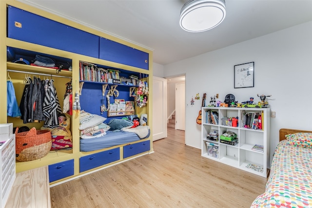 bedroom with wood-type flooring and a closet