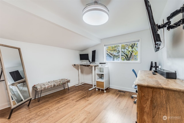 home office with lofted ceiling and light wood-type flooring