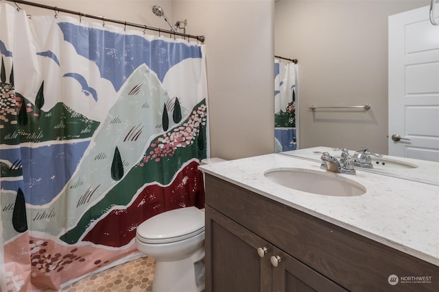 bathroom with curtained shower, toilet, tile patterned floors, and vanity