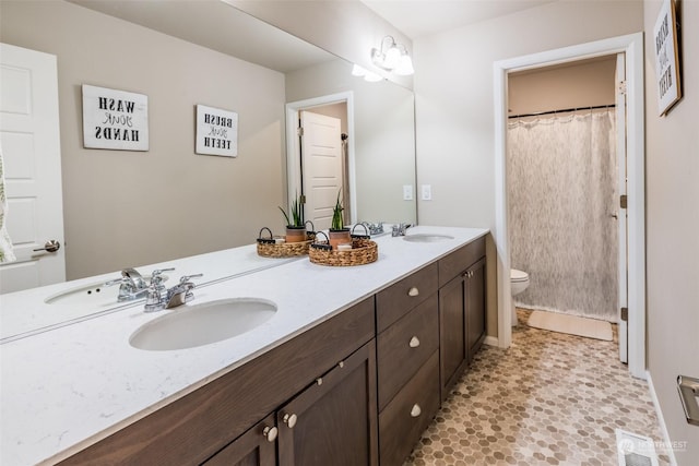 bathroom featuring vanity, toilet, and walk in shower