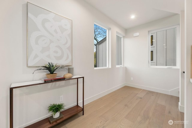 corridor with light hardwood / wood-style floors