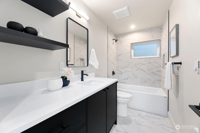 full bathroom featuring vanity, tiled shower / bath, and toilet