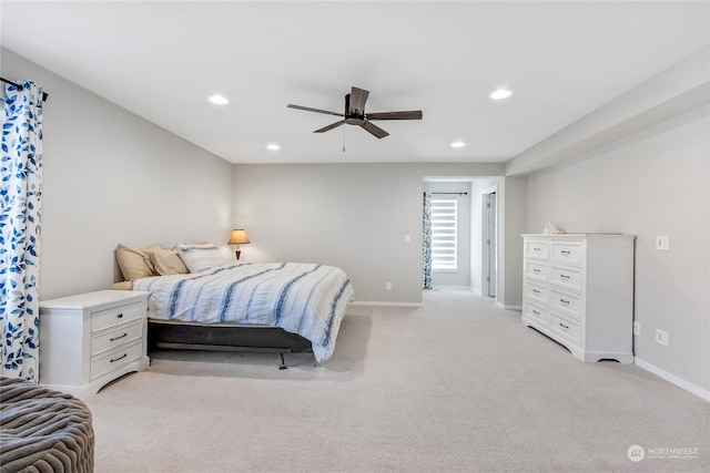 bedroom featuring ceiling fan and light carpet