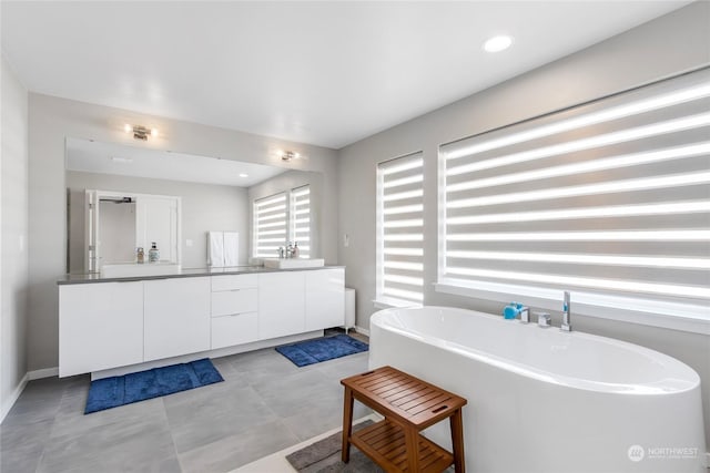 bathroom with a bath and vanity